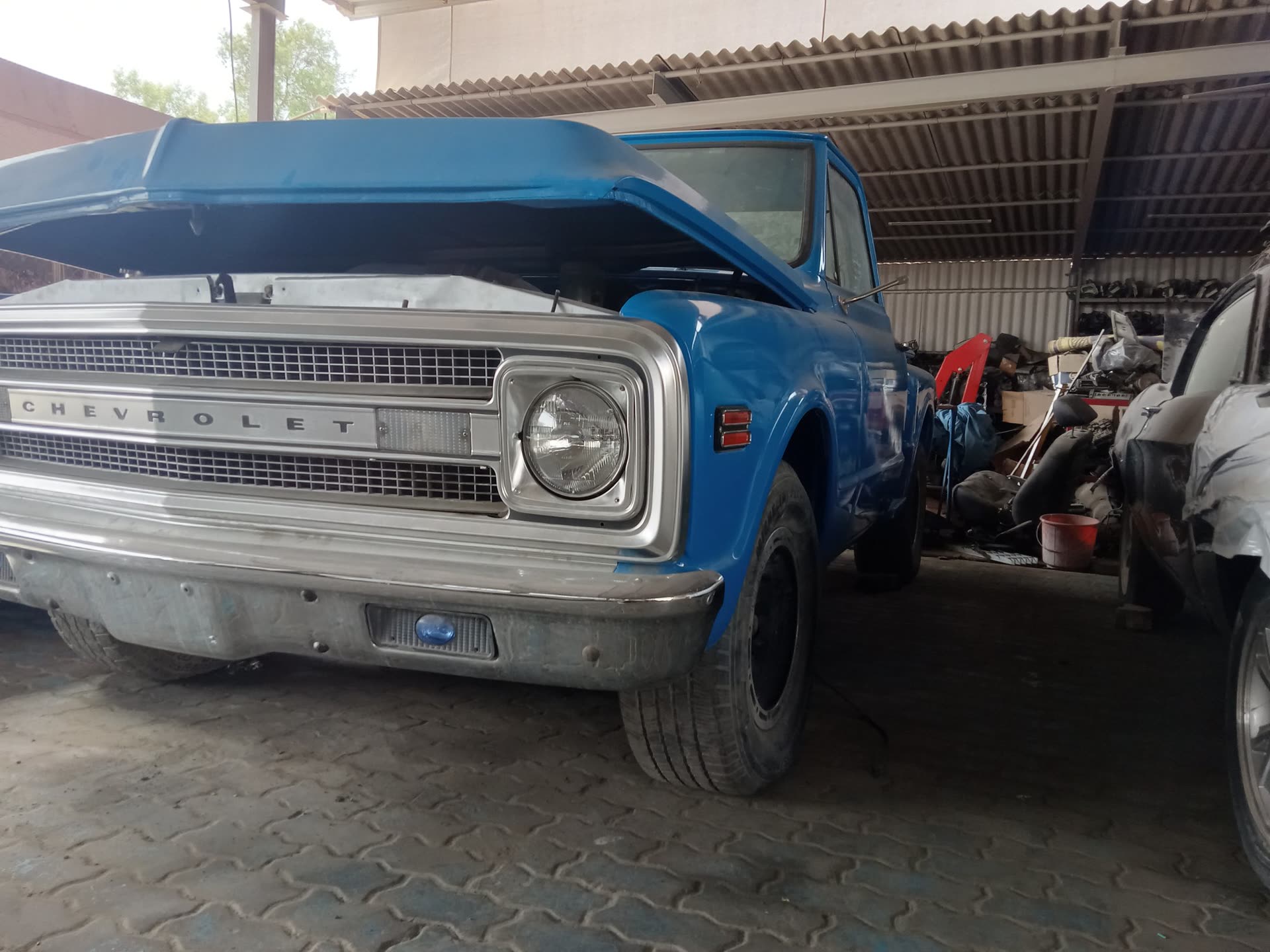 Classic blue Chevrolet truck in a garage where PSS supports electrical modernization projects.