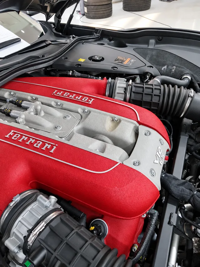 Engine-bay context showing the relationship between the engine, connectors, and electrical harness routing.